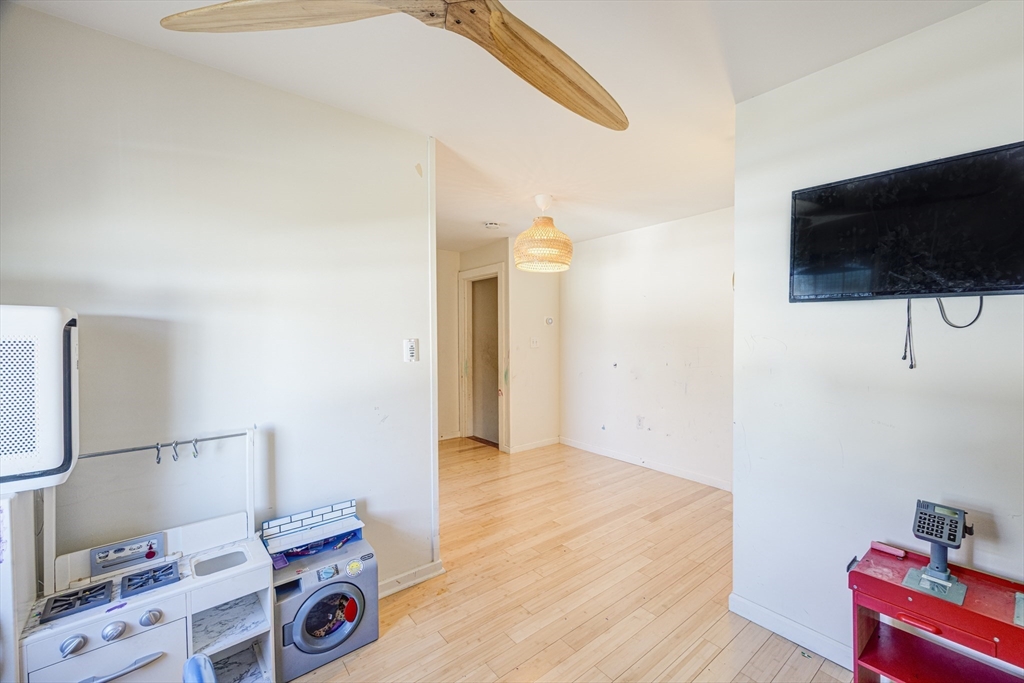707 Hathaway Road New Bedford, MA 02740 - Photo 23 of 33 a bedroom with a bed and flat screen tv