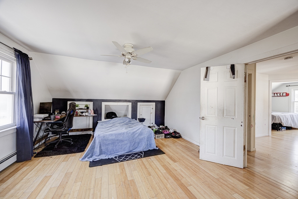 707 Hathaway Road New Bedford, MA 02740 - Photo 24 of 33 a bedroom with a bed and wooden floor