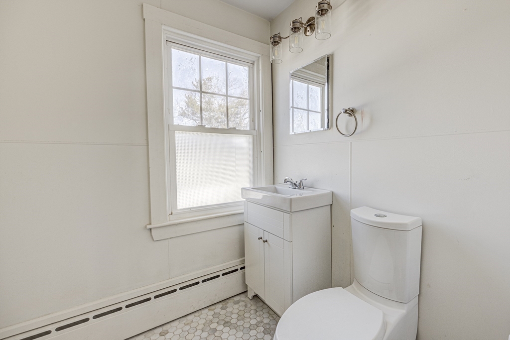 707 Hathaway Road New Bedford, MA 02740 - Photo 27 of 33 a bathroom with a toilet a sink and a window