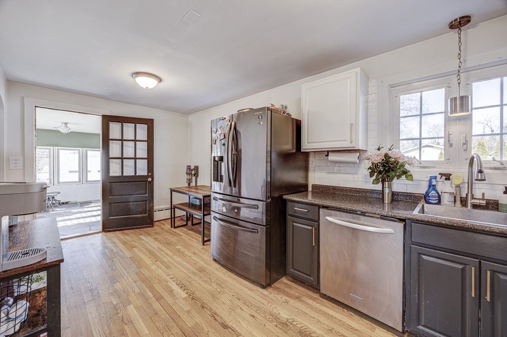 707 Hathaway Road New Bedford, MA 02740 - Photo 7 of 33 a kitchen with stainless steel appliances a refrigerator sink and cabinets