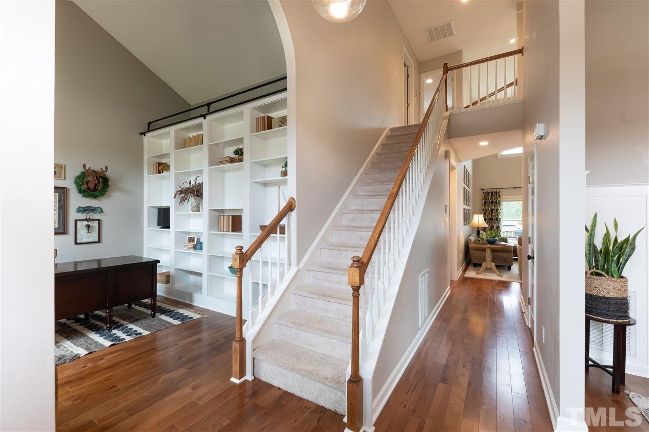 8901 Breeland Way Raleigh, NC 27613 - Photo 11 of 24 a view of entryway and hall with wooden floor