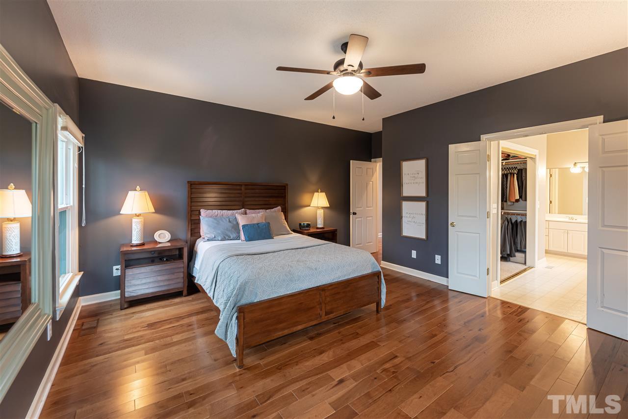 8901 Breeland Way Raleigh, NC 27613 - Photo 12 of 24 a bedroom with a bed and wooden floor
