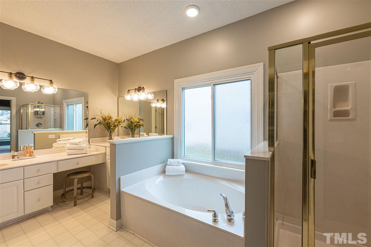 8901 Breeland Way Raleigh, NC 27613 - Photo 14 of 24 a large bathroom with a large tub and sink