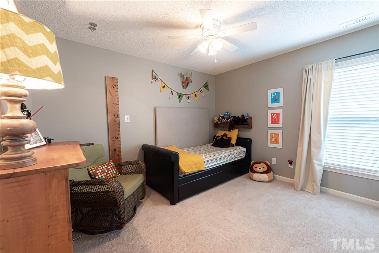 8901 Breeland Way Raleigh, NC 27613 - Photo 15 of 24 a bedroom with furniture and a window