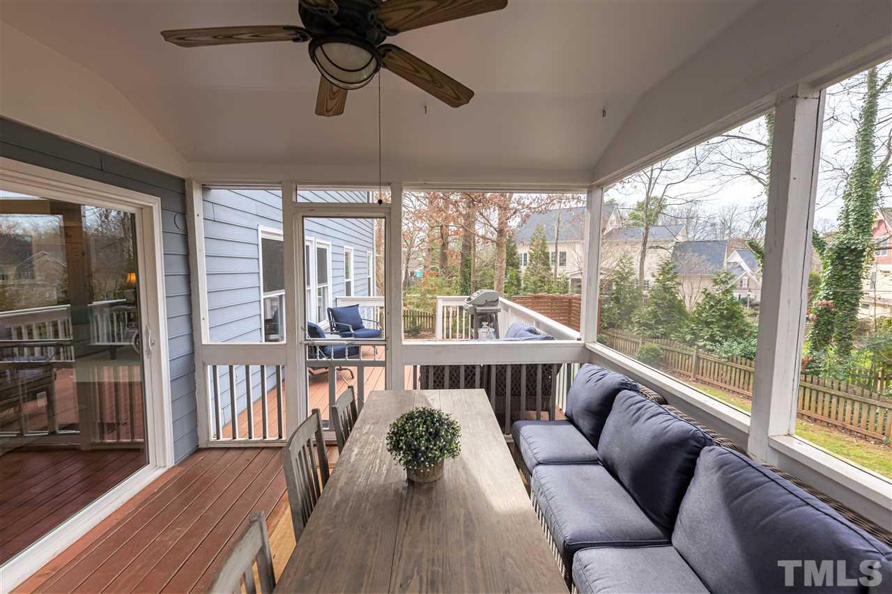 8901 Breeland Way Raleigh, NC 27613 - Photo 22 of 24 a living room with furniture tv and a large window