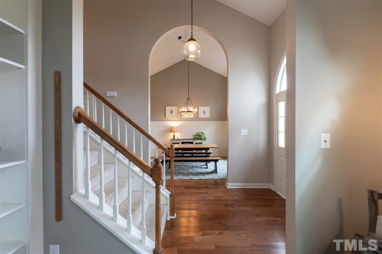 8901 Breeland Way Raleigh, NC 27613 - Photo 9 of 24 a view of staircase and kitchen with wooden floor