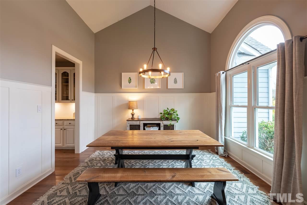 8901 Breeland Way Raleigh, NC 27613 - Photo 10 of 24 a living room with furniture and a chandelier