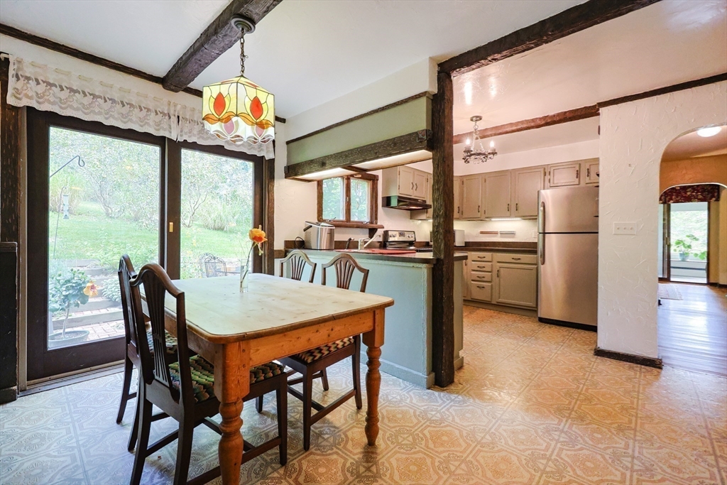 58 Pine Hill Road Southborough, MA 01772 - Photo 17 of 42 a dining room with furniture a chandelier and wooden floor