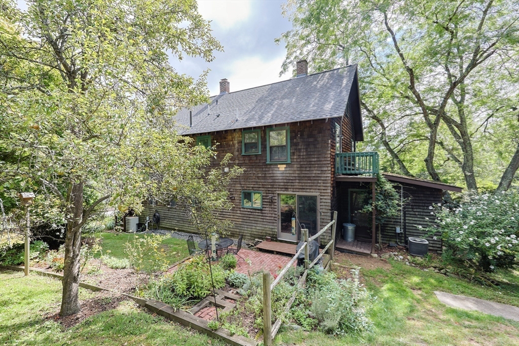 58 Pine Hill Road Southborough, MA 01772 - Photo 8 of 42 a view of a wooden house with a yard and large trees