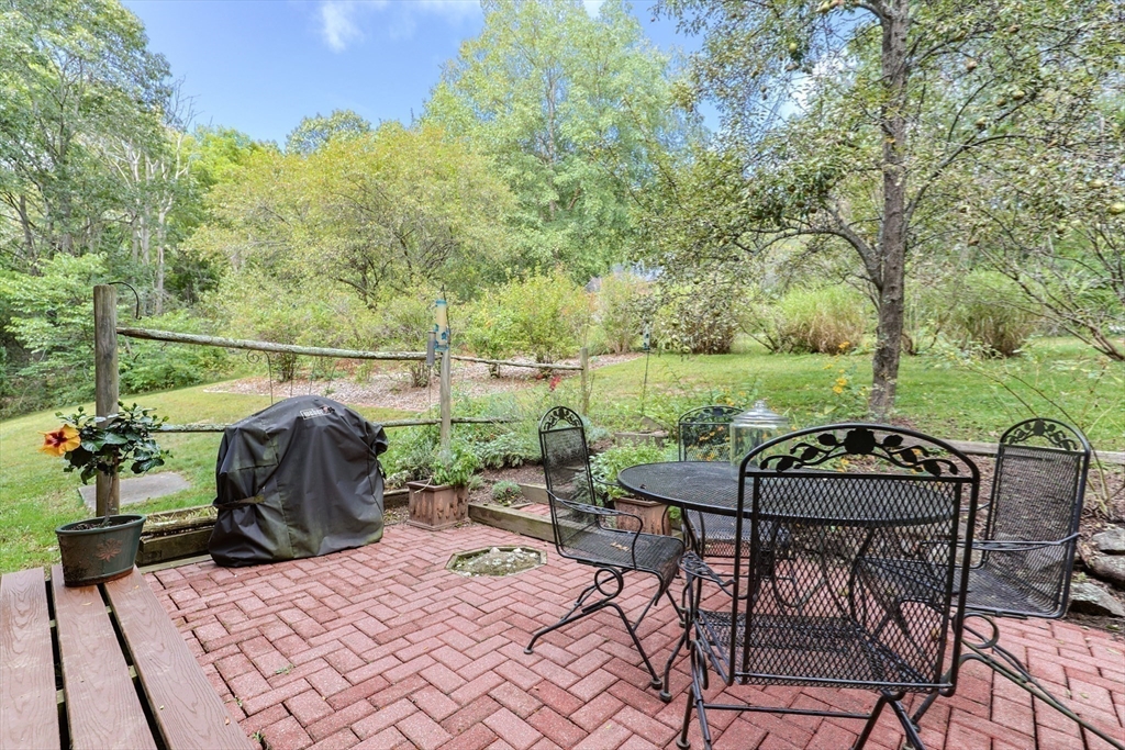 58 Pine Hill Road Southborough, MA 01772 - Photo 9 of 42 a view of a patio with table and chairs potted plants with wooden floor and fence