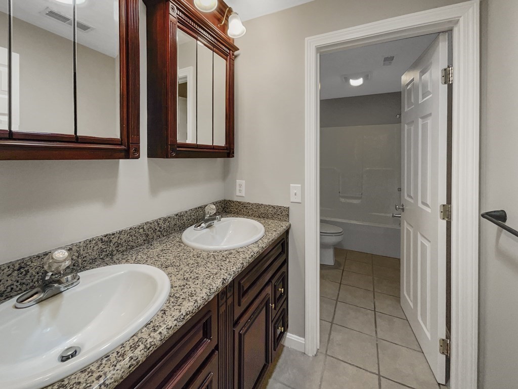 24 Sophia Drive Worcester, MA 01607 - Photo 19 of 30 a bathroom with a granite countertop sink and a mirror