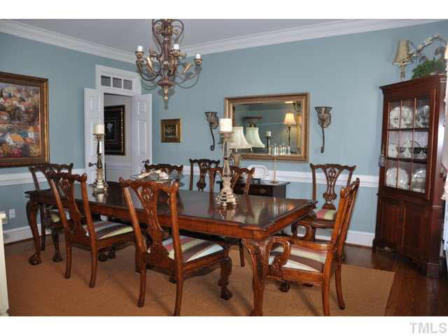 8904 Windjammer Drive Raleigh, NC 27615 - Photo 7 of 25 Formal dining at its finest--plantation shutters, hardwood floors, heavy crown molding, chair rail, transoms and double doors Dining Room