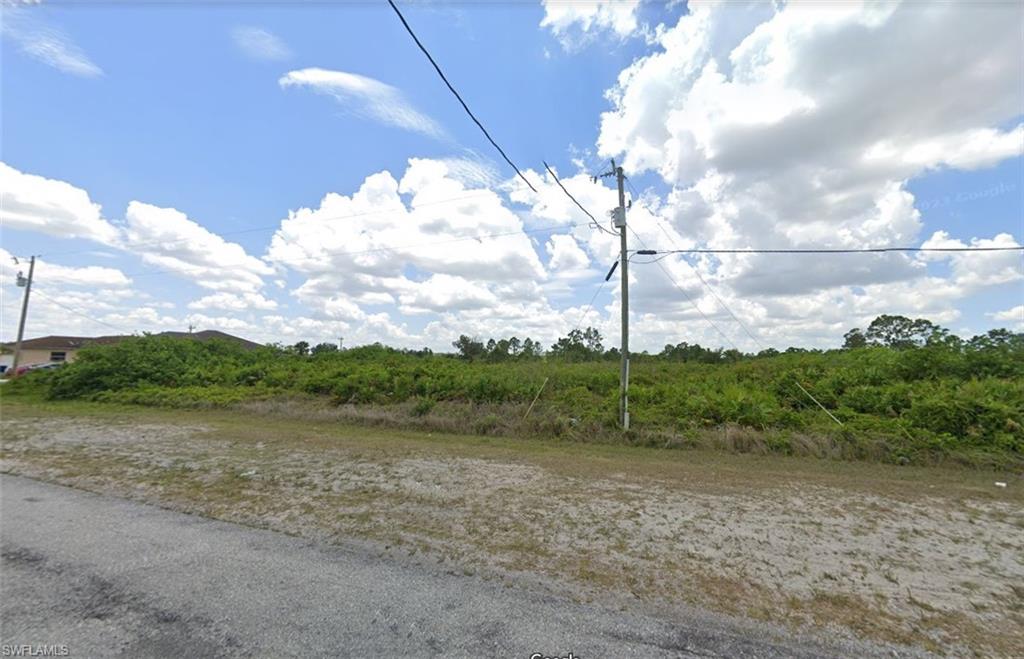 902 Grant Boulevard Lehigh Acres, FL 33974 - Photo 2 of 4 a view of lake with mountain