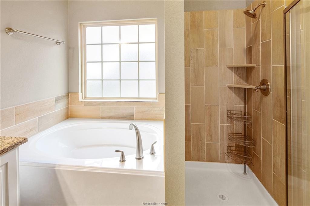 2027 Stubbs Drive Bryan, TX 77807 - Photo 13 of 23 Full bath featuring a bath, a stall shower, and va