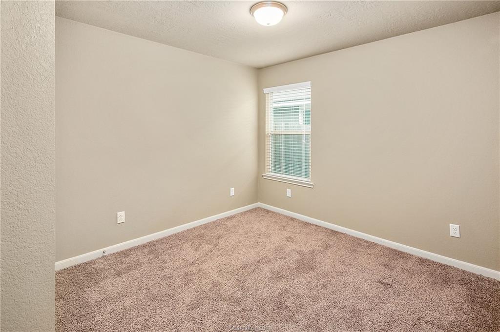 2027 Stubbs Drive Bryan, TX 77807 - Photo 18 of 23 Carpeted spare room featuring baseboards and a tex