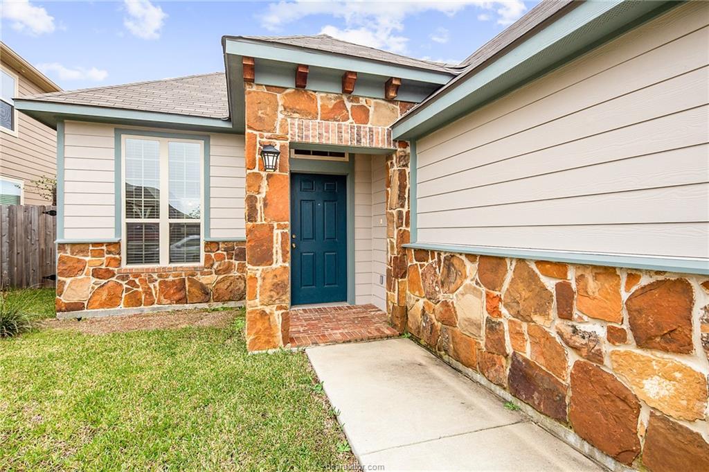 2027 Stubbs Drive Bryan, TX 77807 - Photo 3 of 23 Property entrance featuring stone siding, a yard,