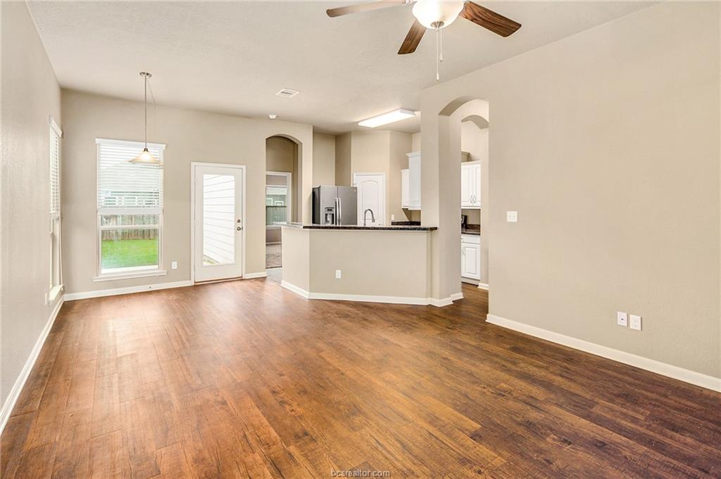 2027 Stubbs Drive Bryan, TX 77807 - Photo 5 of 23 Unfurnished living room featuring dark wood finish