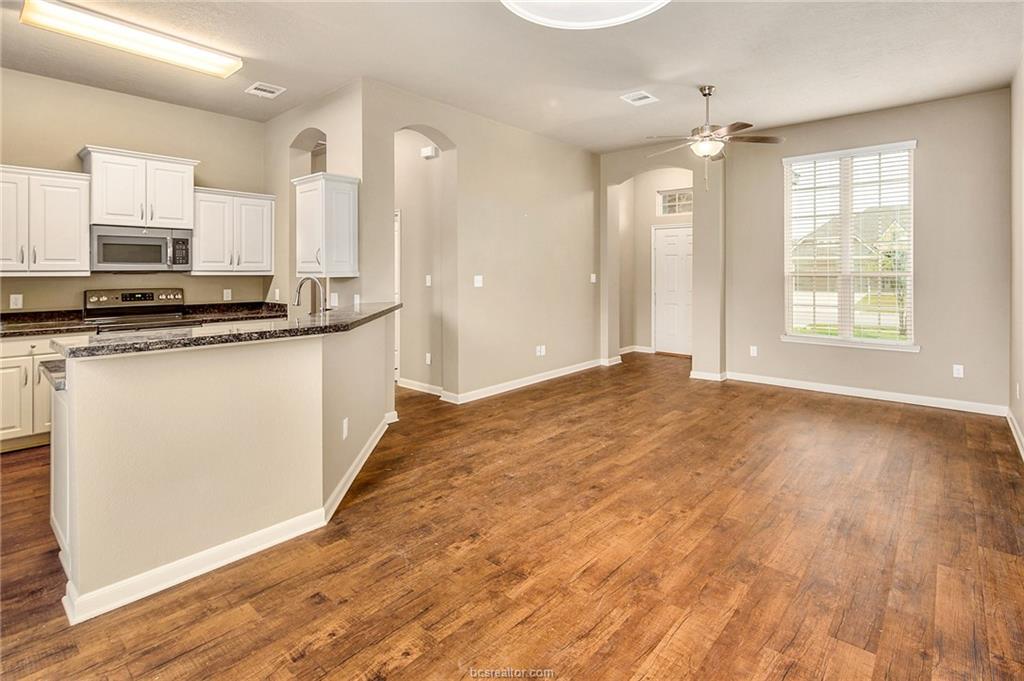 2027 Stubbs Drive Bryan, TX 77807 - Photo 6 of 23 Kitchen featuring white cabinetry, arched walkways