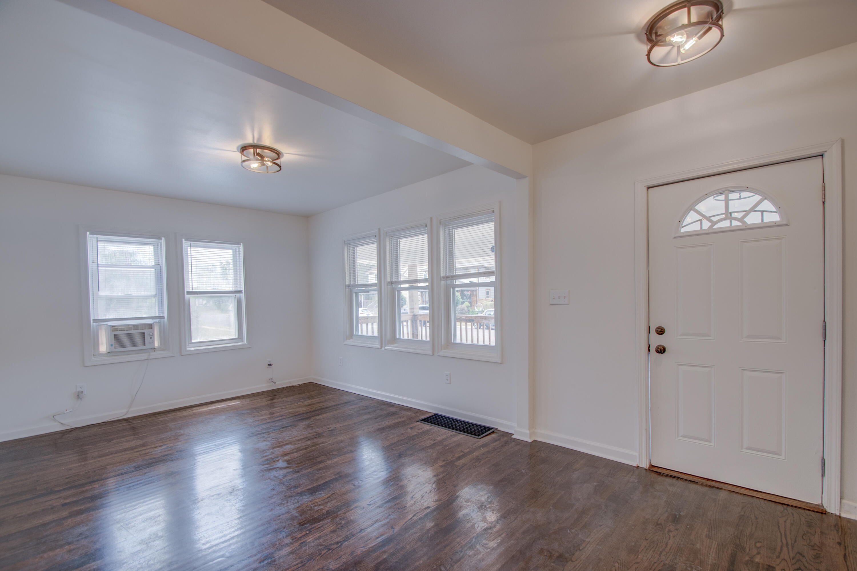 613 Tennessee Street Gary, IN 46402 - Photo 19 of 39 an empty room with wooden floor and windows
