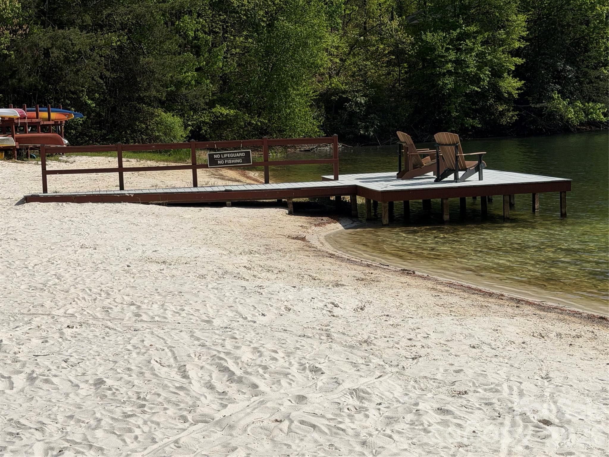 0 Lakeview Drive, Unit 414/415 Tryon, NC 28782 - Photo 24 of 25 a view of a lake with a bench and trees
