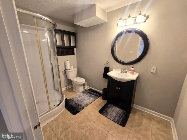 a bathroom with a toilet a sink and a mirror