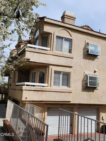 a view of a house with a wooden deck