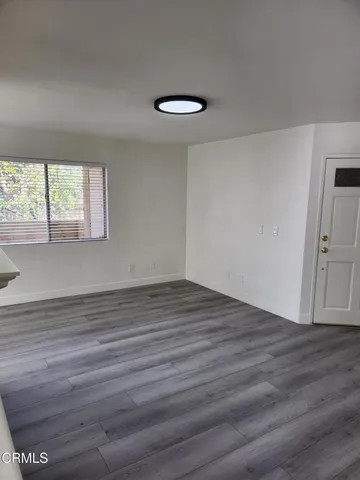 a view of wooden floor and windows in a room
