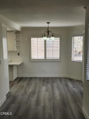 a view of a livingroom with wooden floor and a fireplace