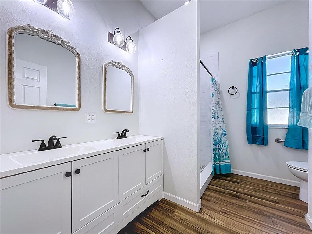 18812 Bascomb Lane Hudson, FL 34667 - Photo 45 of 57 a bathroom with a sink and a mirror