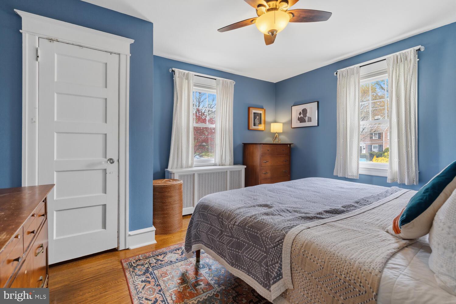 2116 East County Line Road Ardmore, PA 19003 - Photo 21 of 38 a bedroom with a bed and a chandelier