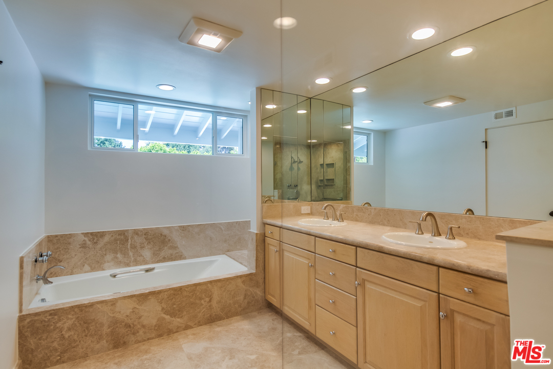 13133 Morrison Street Sherman Oaks, CA 91423 - Photo 14 of 26 a bathroom with a tub sink and mirror