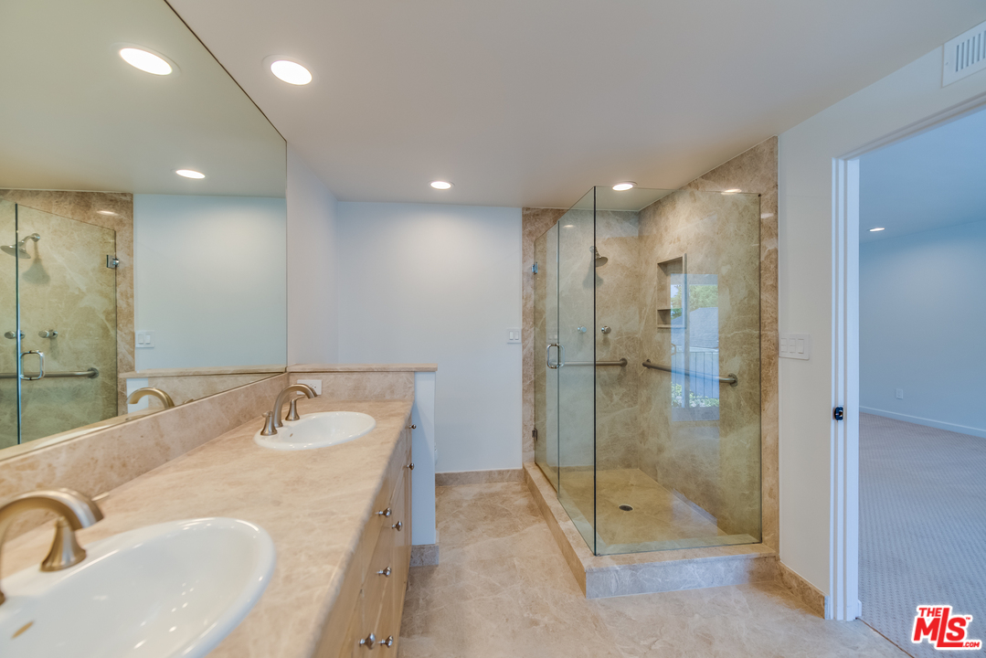 13133 Morrison Street Sherman Oaks, CA 91423 - Photo 15 of 26 a bathroom with a tub sink mirror and shower