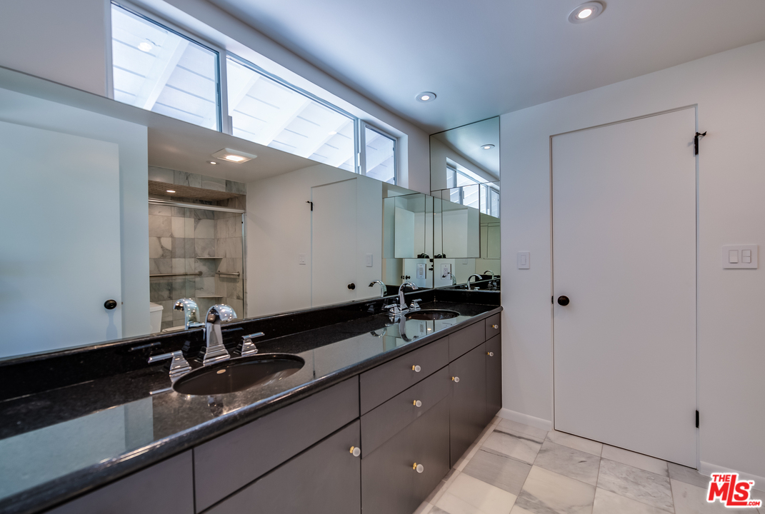 13133 Morrison Street Sherman Oaks, CA 91423 - Photo 19 of 26 a bathroom with double sink and a mirror