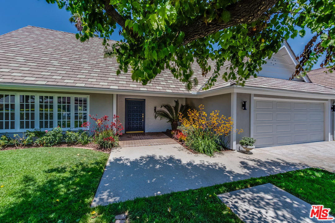 13133 Morrison Street Sherman Oaks, CA 91423 - Photo 3 of 26 a front view of a house with garden