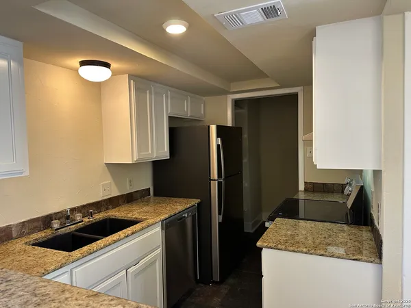 a kitchen that has a sink and a refrigerator