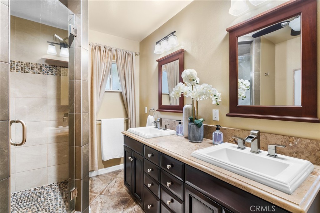 4651 Emerson Street Riverside, CA 92506 - Photo 13 of 30 a bathroom with a double vanity sink mirror and shower