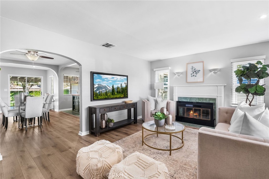 4651 Emerson Street Riverside, CA 92506 - Photo 2 of 30 a living room with furniture a fireplace and a flat screen tv