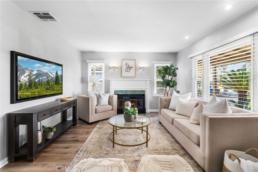 4651 Emerson Street Riverside, CA 92506 - Photo 3 of 30 a living room with furniture a flat screen tv and a fireplace