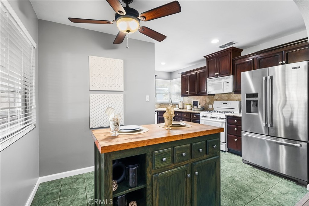 4651 Emerson Street Riverside, CA 92506 - Photo 7 of 30 a kitchen with a refrigerator a stove a sink and a microwave