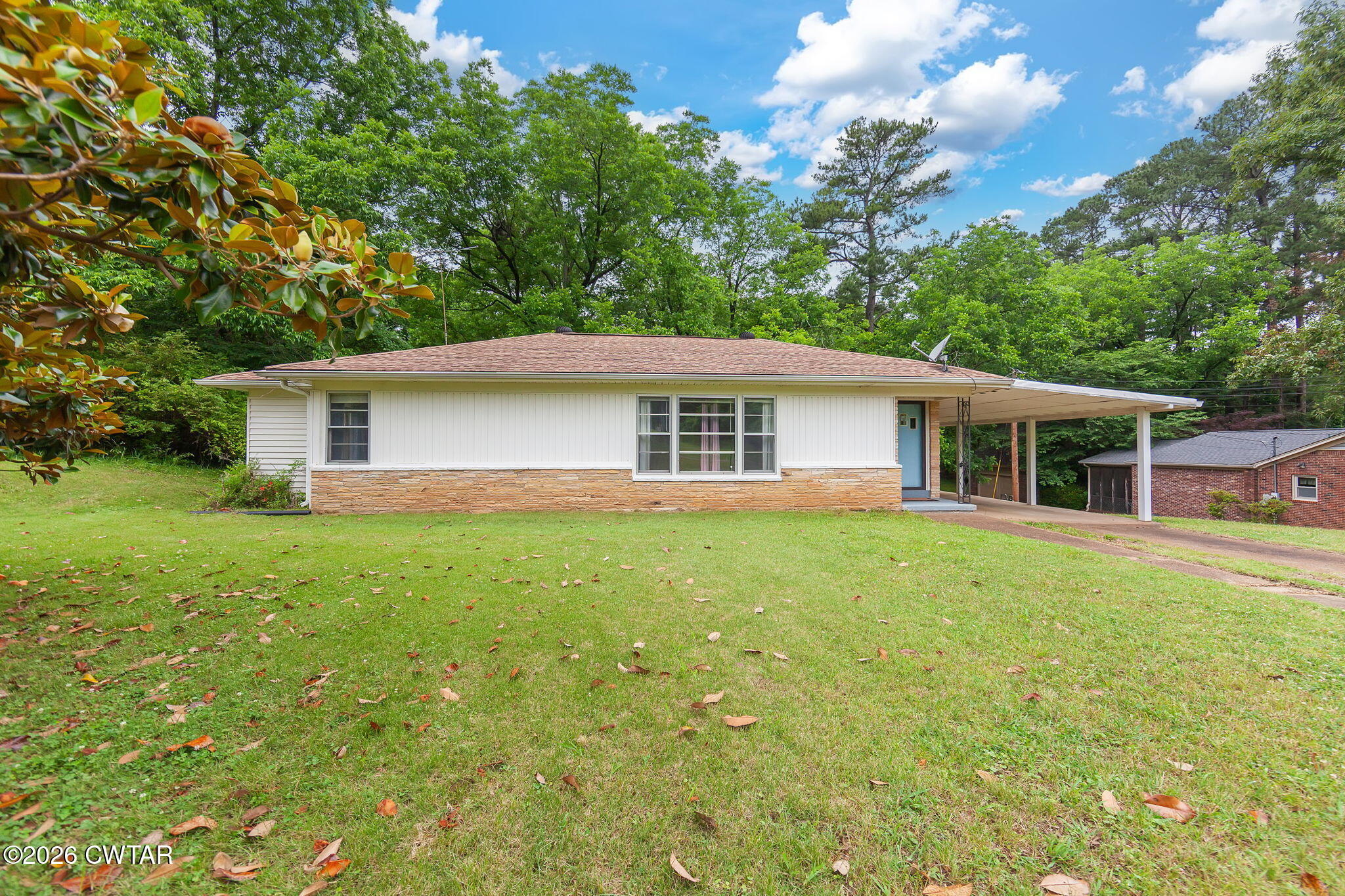 a front view of house with yard and green space