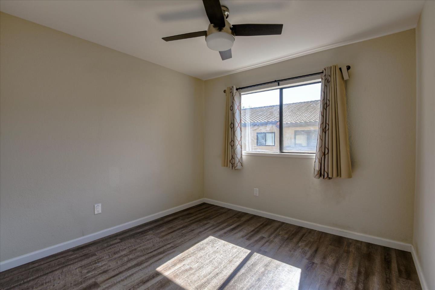 46948 Shale Common, Unit 112 Fremont, CA 94539 - Photo 14 of 30 wooden floor in an empty room with a window