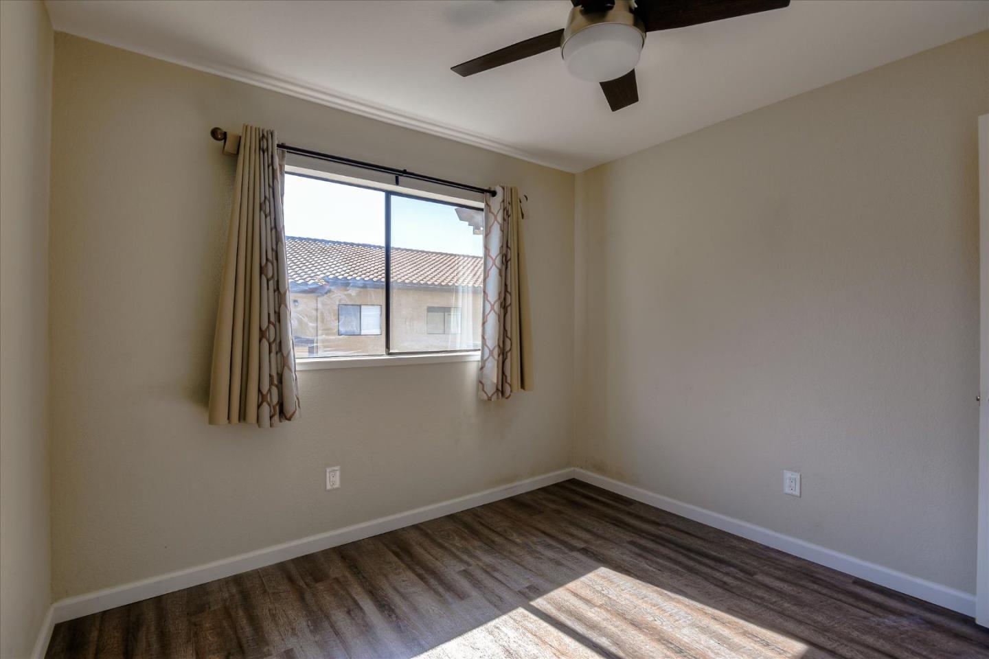 46948 Shale Common, Unit 112 Fremont, CA 94539 - Photo 16 of 30 an empty room with wooden floor and windows