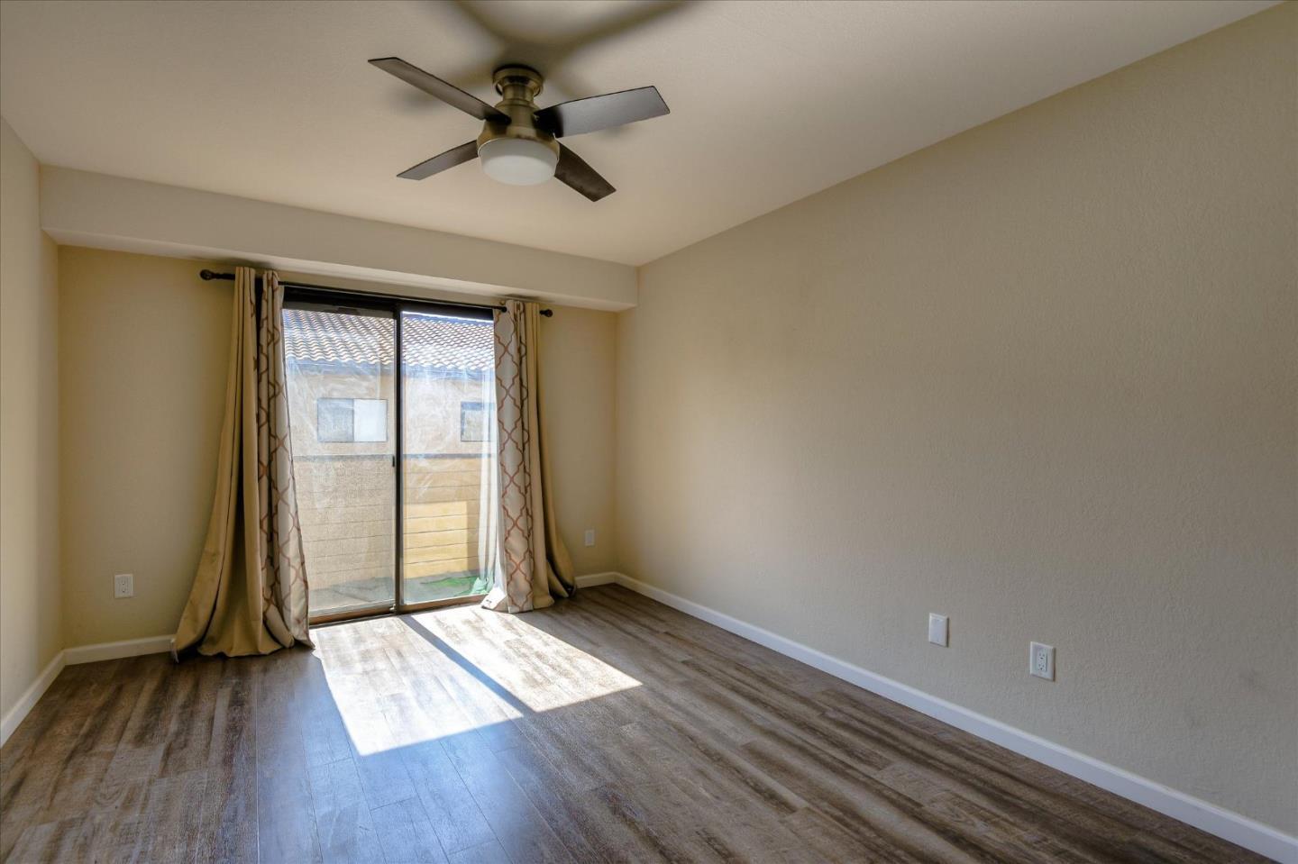 46948 Shale Common, Unit 112 Fremont, CA 94539 - Photo 20 of 30 wooden floor in an empty room with a window