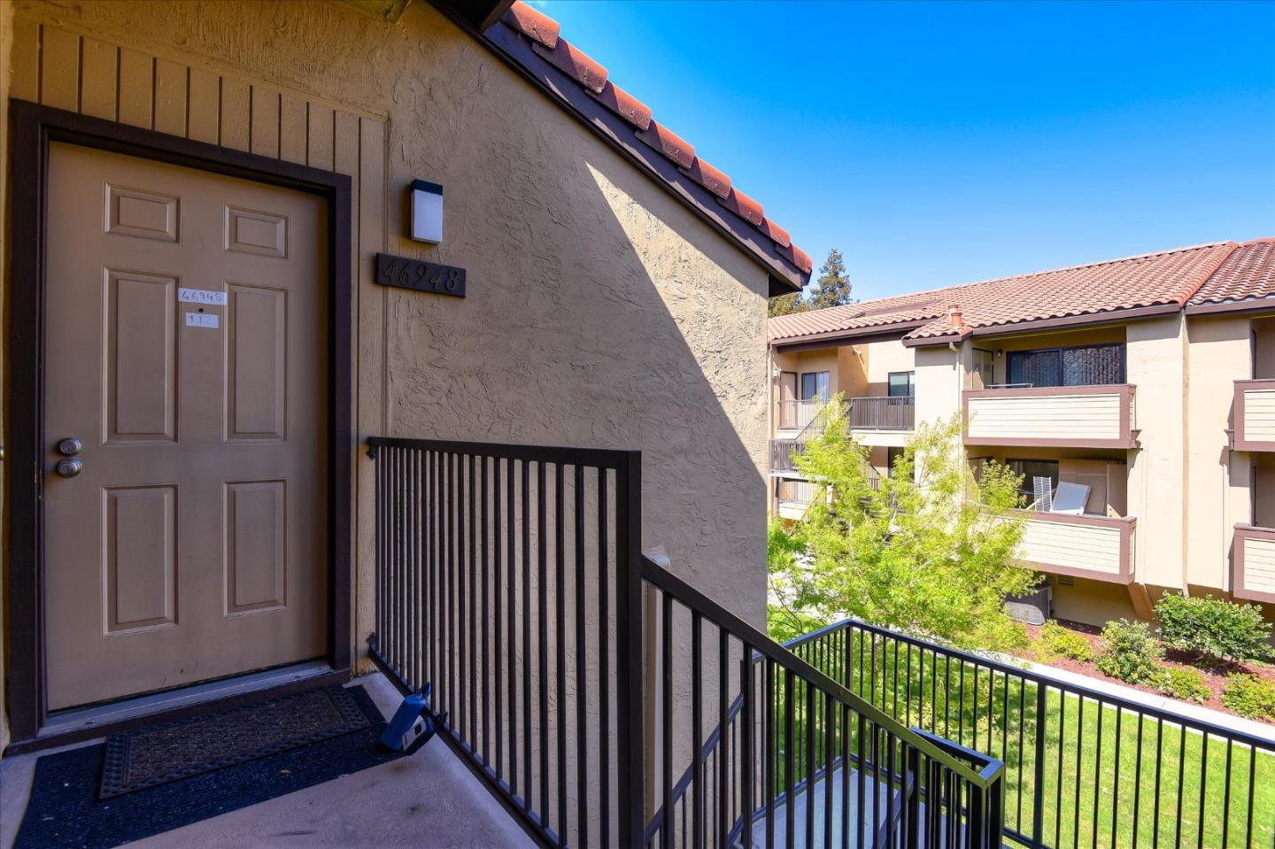 46948 Shale Common, Unit 112 Fremont, CA 94539 - Photo 2 of 30 a view of a house with a window and wooden fence
