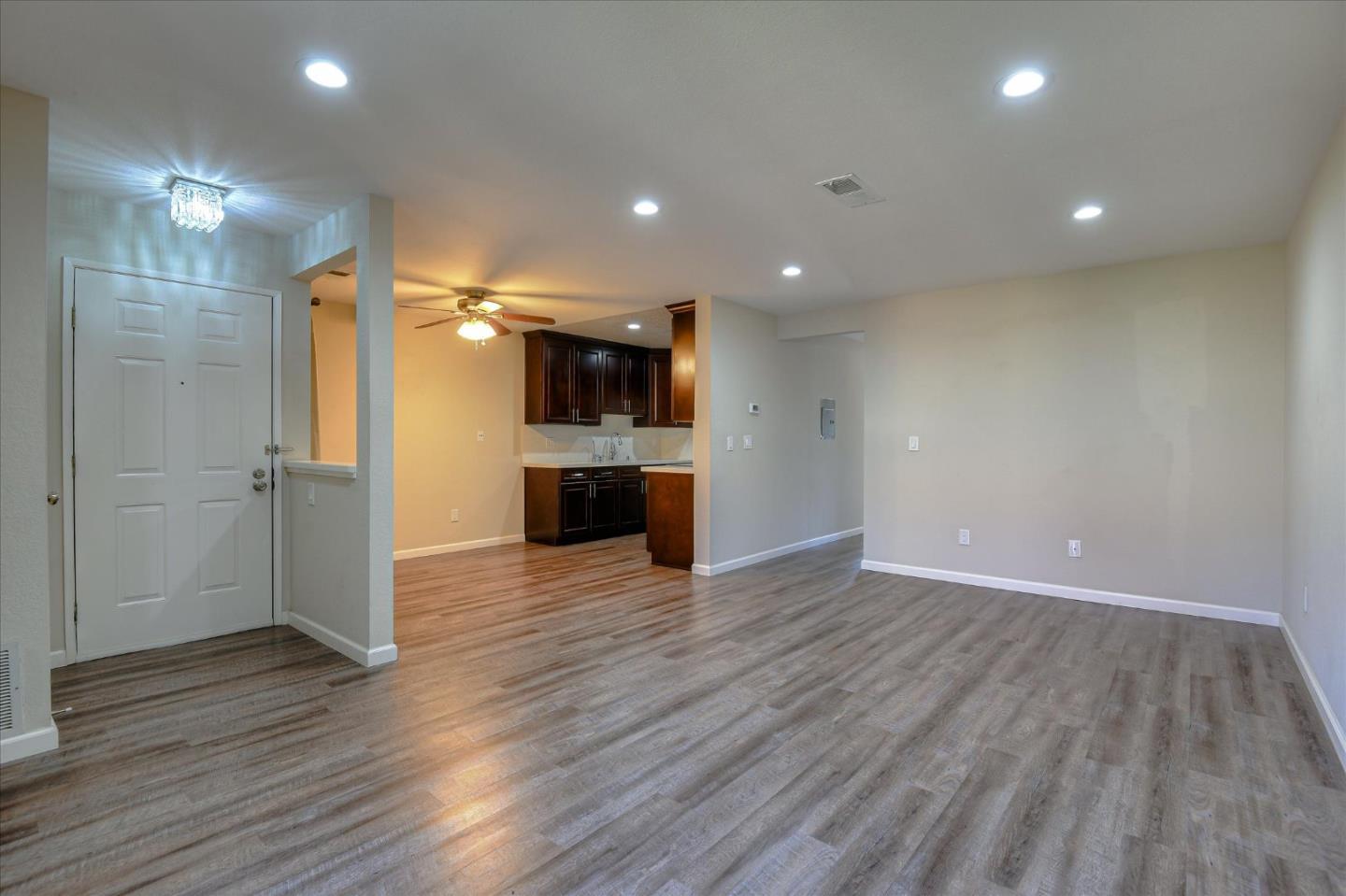 46948 Shale Common, Unit 112 Fremont, CA 94539 - Photo 9 of 30 a view of empty room with wooden floor and a fireplace