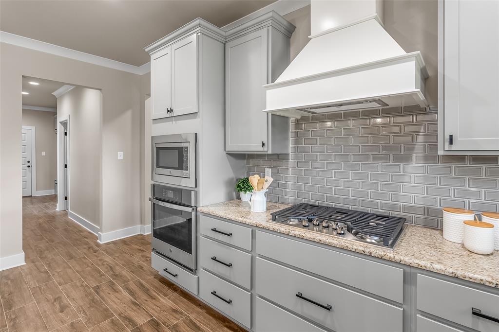 125 Sitka Loop Haughton, LA 71037 - Photo 14 of 29 a kitchen with granite countertop cabinets and wooden floor