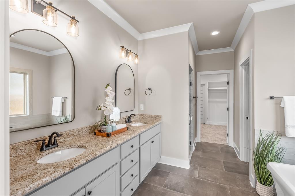 125 Sitka Loop Haughton, LA 71037 - Photo 18 of 29 a spacious bathroom with a granite countertop sink a mirror and a shower