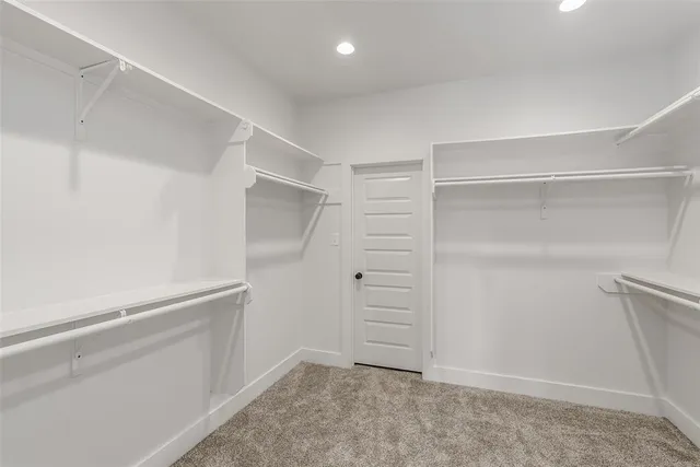 an empty room with a window and a ceiling fan