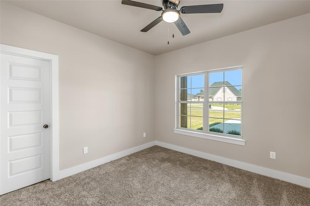 125 Sitka Loop Haughton, LA 71037 - Photo 22 of 29 an empty room with a window and a ceiling fan