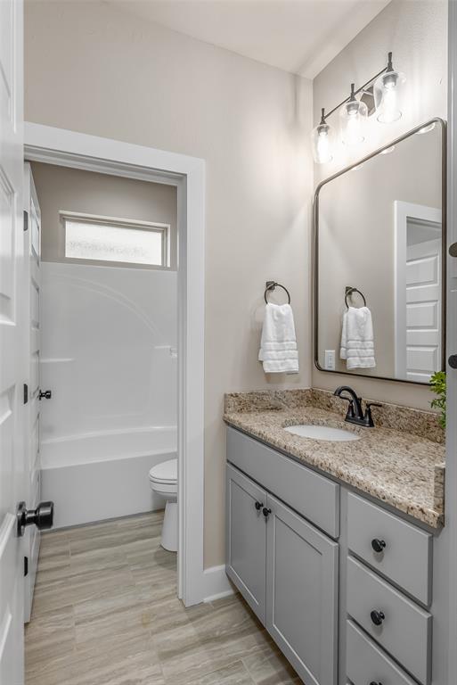 125 Sitka Loop Haughton, LA 71037 - Photo 23 of 29 a bathroom with a granite countertop sink mirror toilet and bathtub